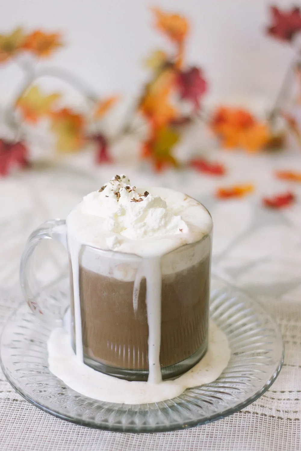 Glass of low carb hot chocolate with keto whipped cream.