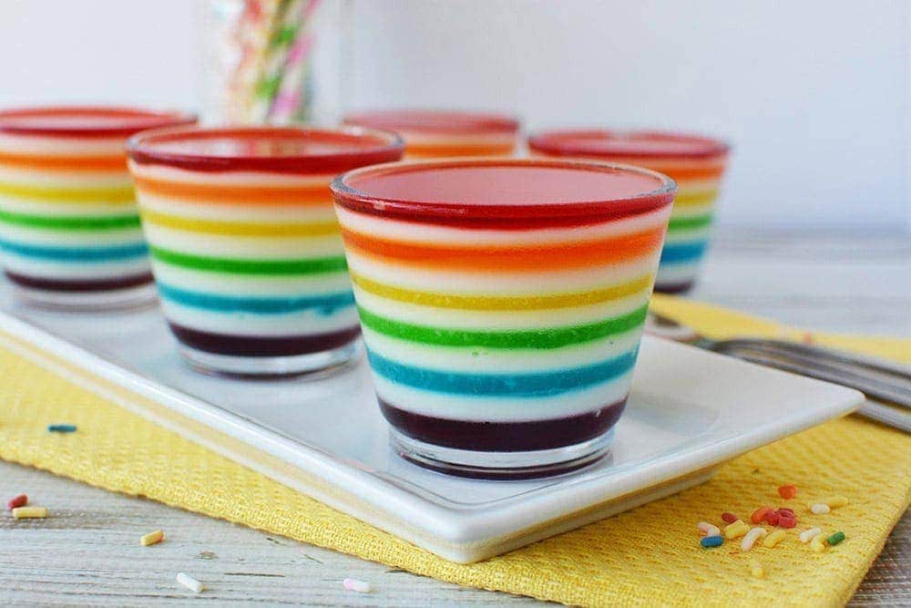 Layered jello into rainbow colors in glass cups. 