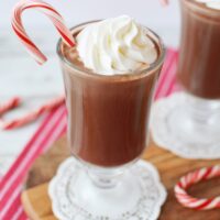 Peppermint mocha in a mug with candy cane