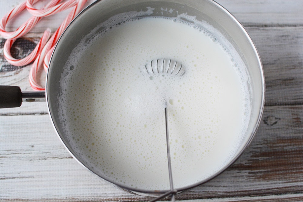 Milk heating in a saucepan.