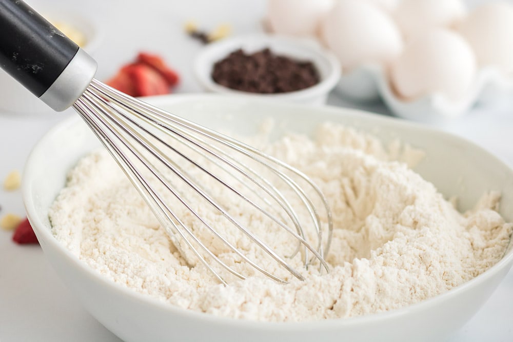 Flour and a whisk in a bowl. 
