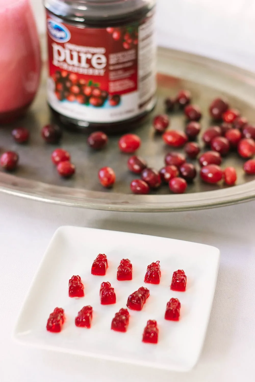 Gummy bears on a plate with cranberries.