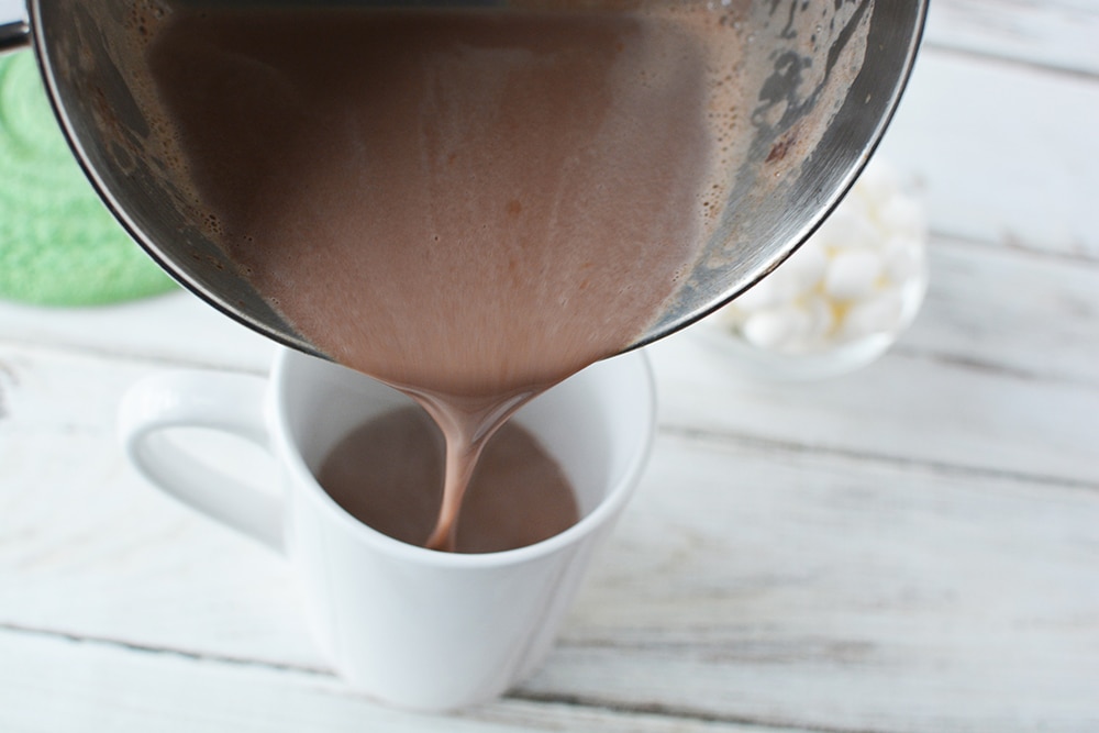 Pouring hot chocolate into a mug.