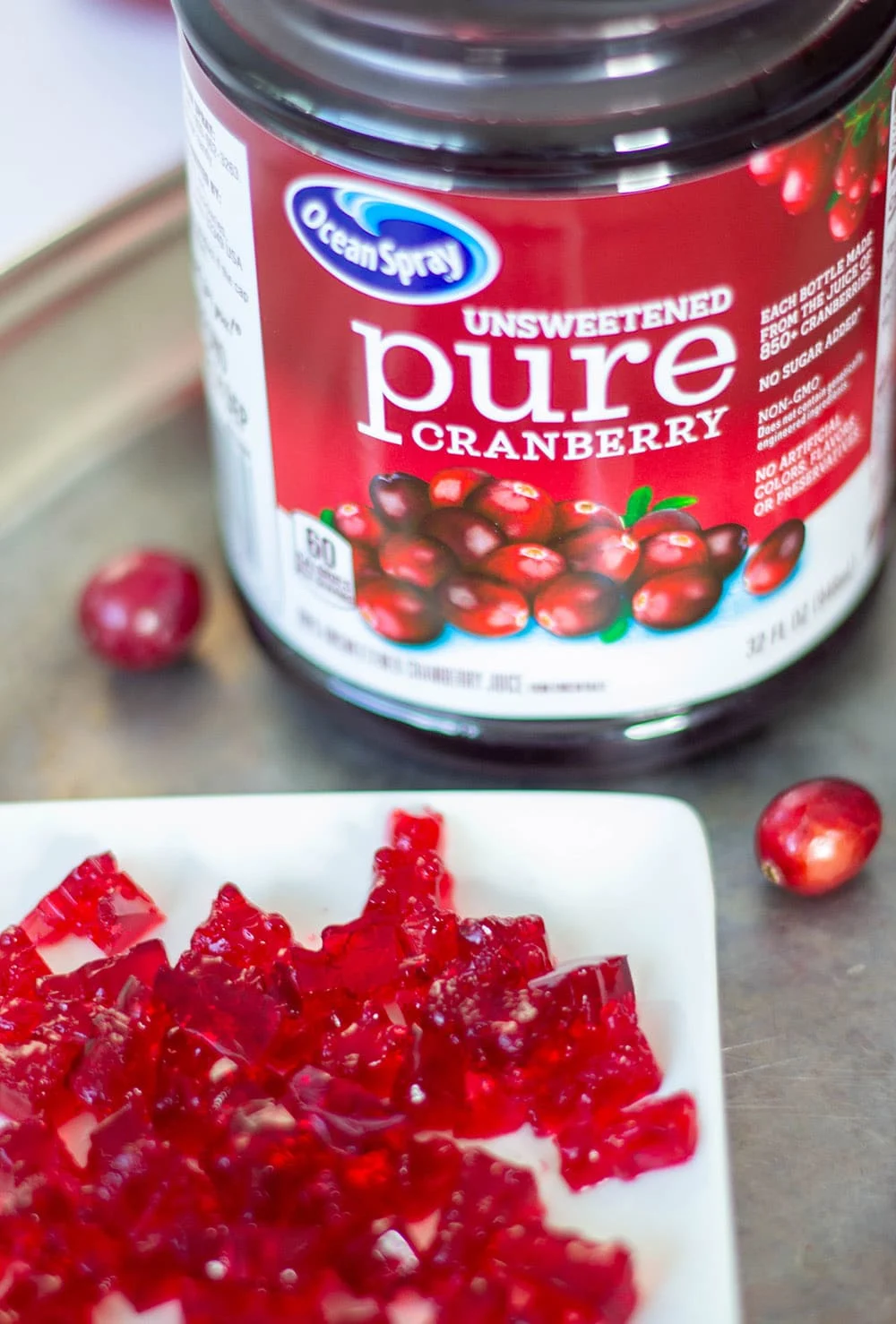 Pile of gummy bears and cranberry juice.