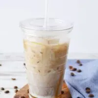 Iced coffee with caramel in a tumbler with straw