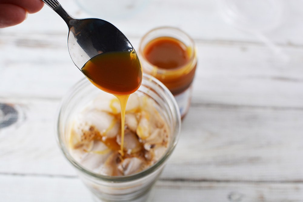 Drizzling in caramel into coffee drink.