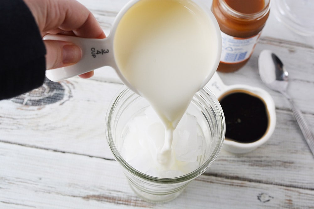 Pouring milk into tumbler.