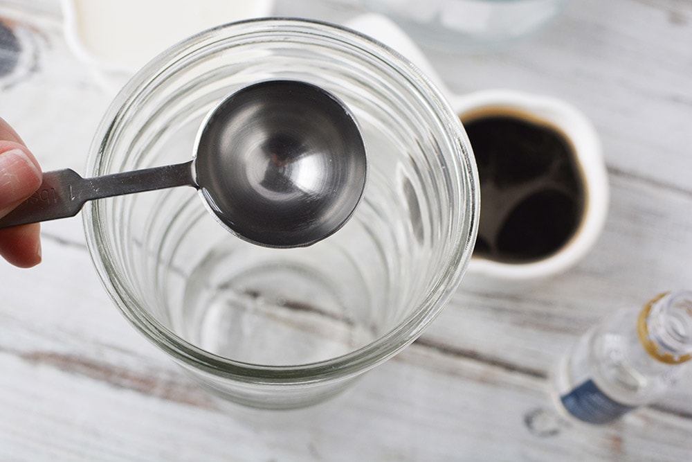 Pouring syrup into a tumbler. 