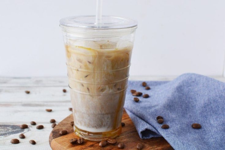 Coffee drink surrounded by coffee beans