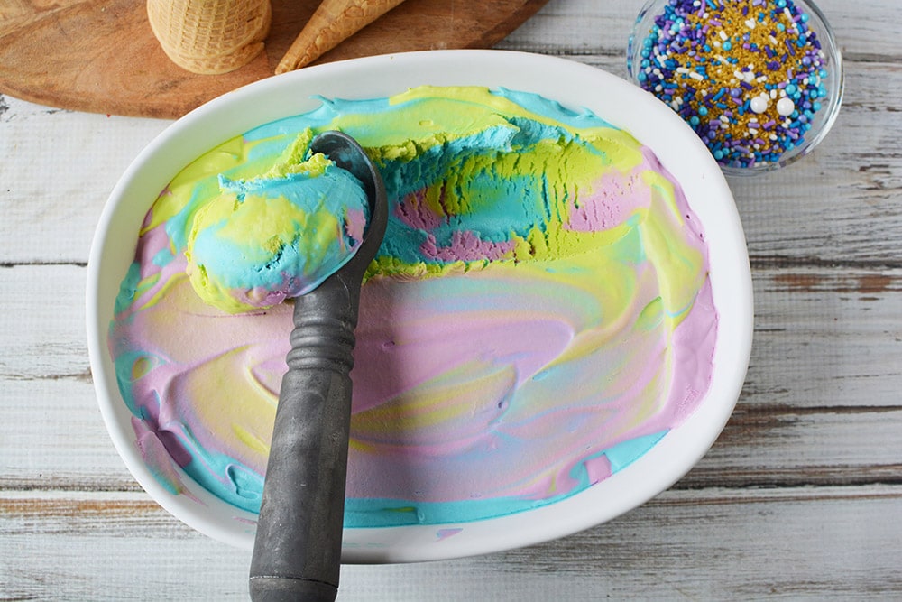 Scooping mermaid ice cream to reveal colors.