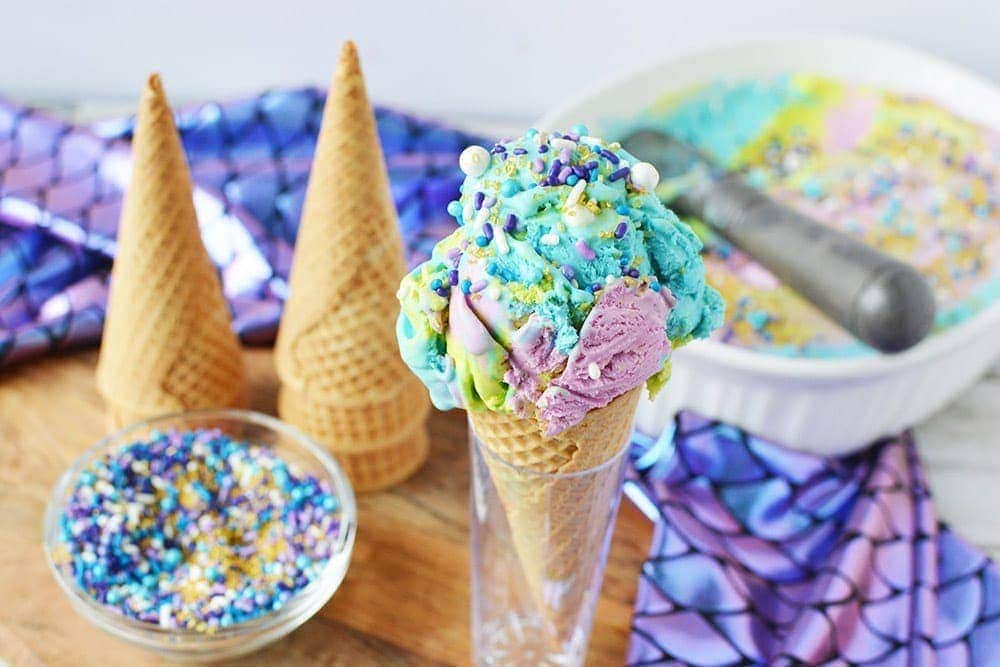 Mermaid ice cream in a cone with sprinkles.