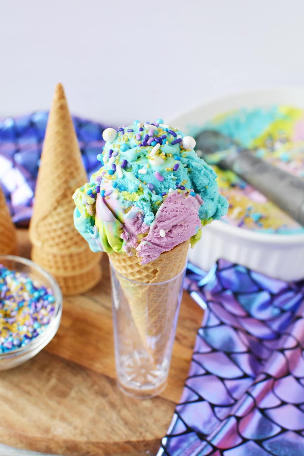 Mermaid ice cream in a cone in a holder on table