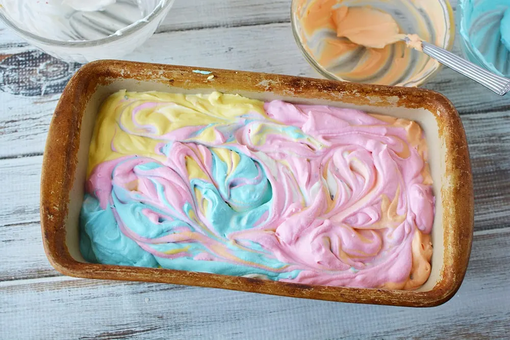 Swirled unicorn ice cream in a loaf pan.