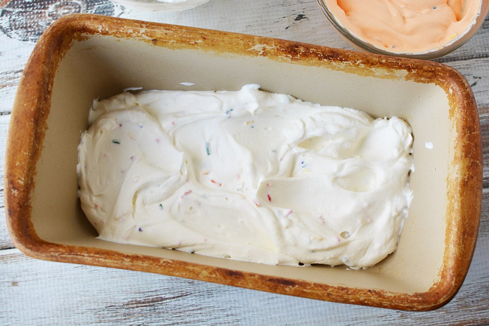 Layer of white ice cream in a loaf pan.