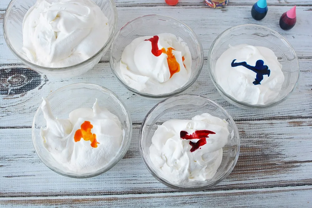 Adding food coloring to ice cream bowls.