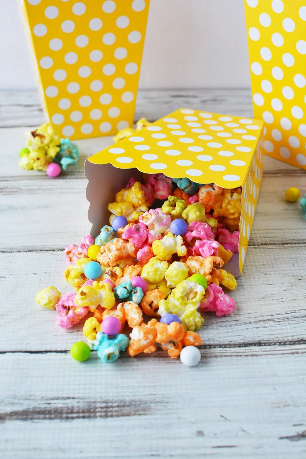 Rainbow unicorn popcorn in yellow popcorn boxes.