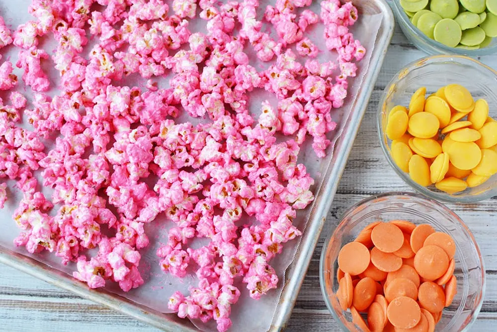 Pink popcorn on a baking sheet.