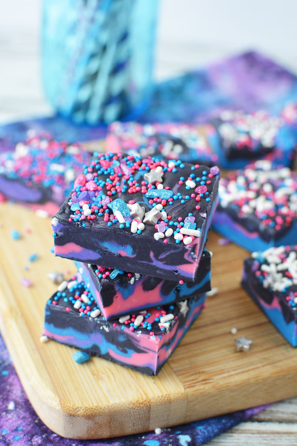 Stacked galaxy fudge with slices on a board.