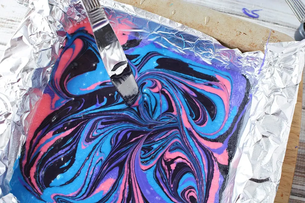 Swirling galaxy fudge with a knife.