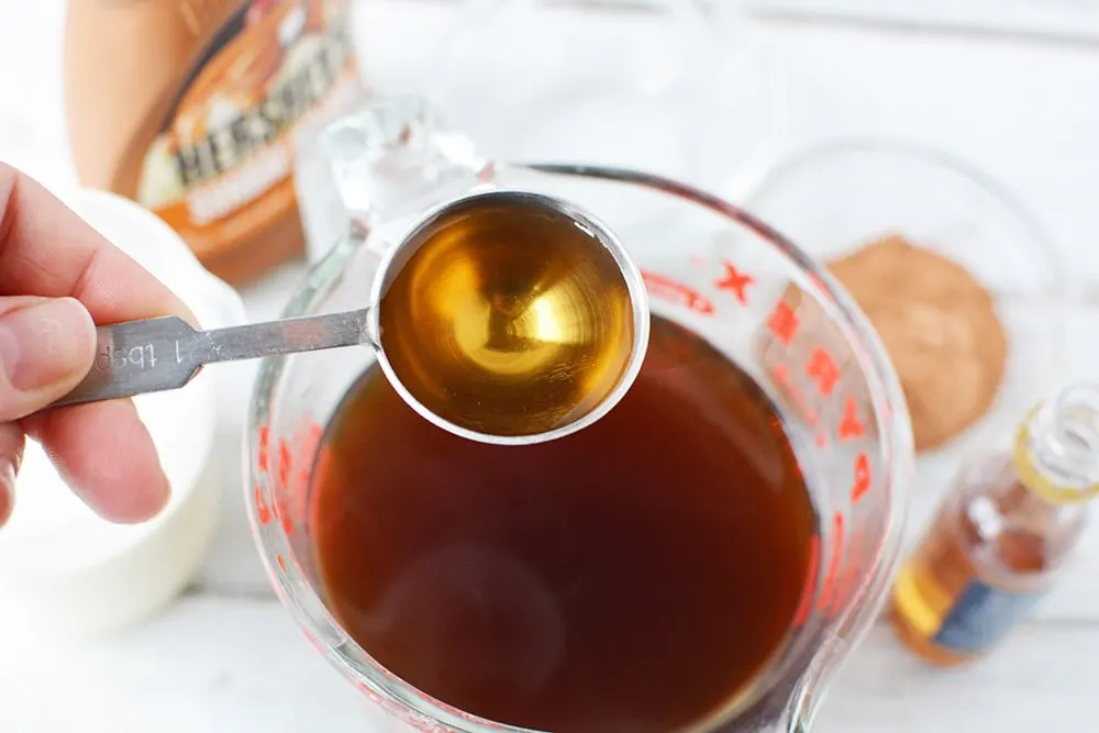 Adding caramel syrup into coffee.