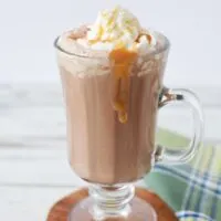 Salted caramel mocha in a glass with caramel dripping down sides