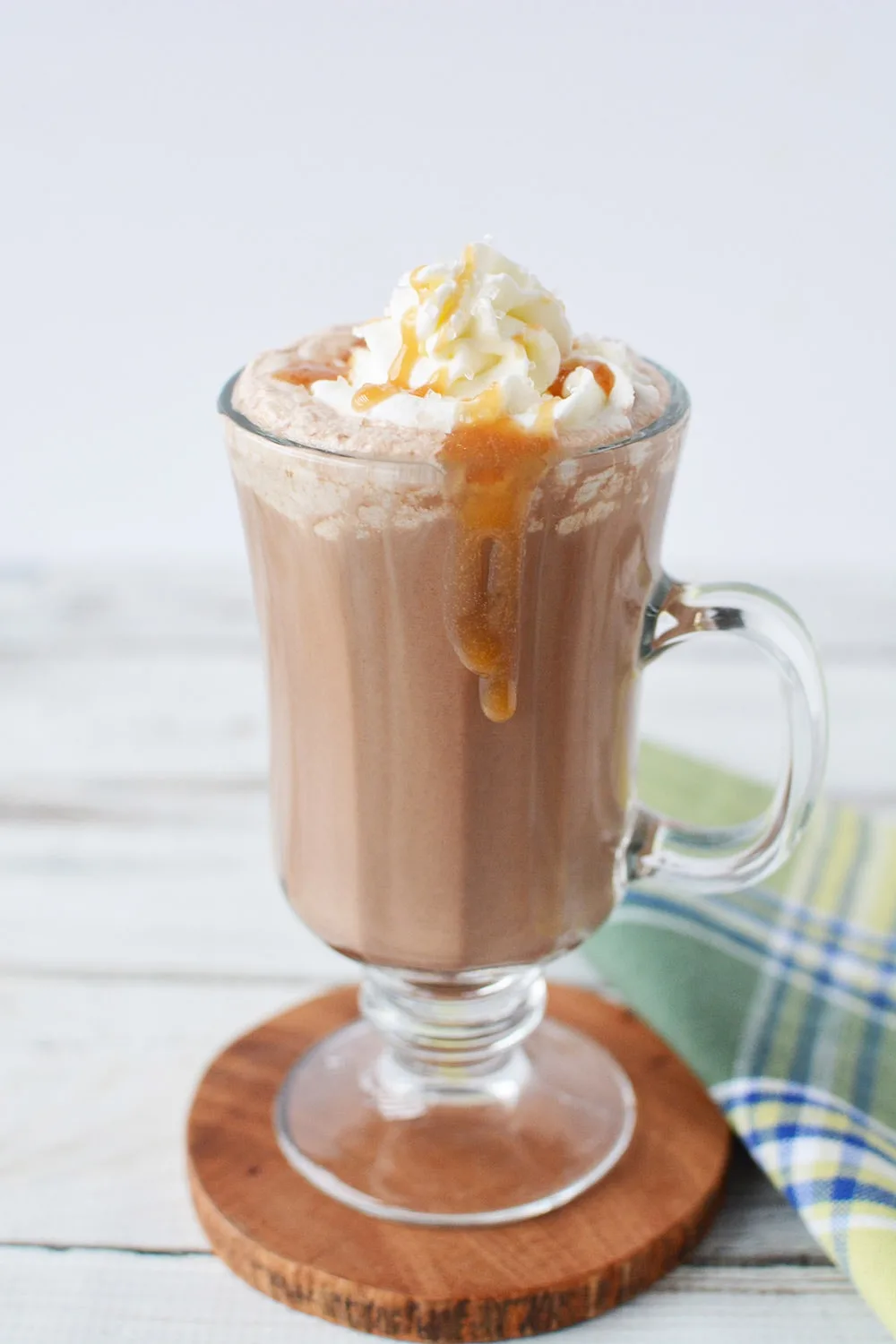 Salted caramel mocha in a glass with caramel dripping down sides.