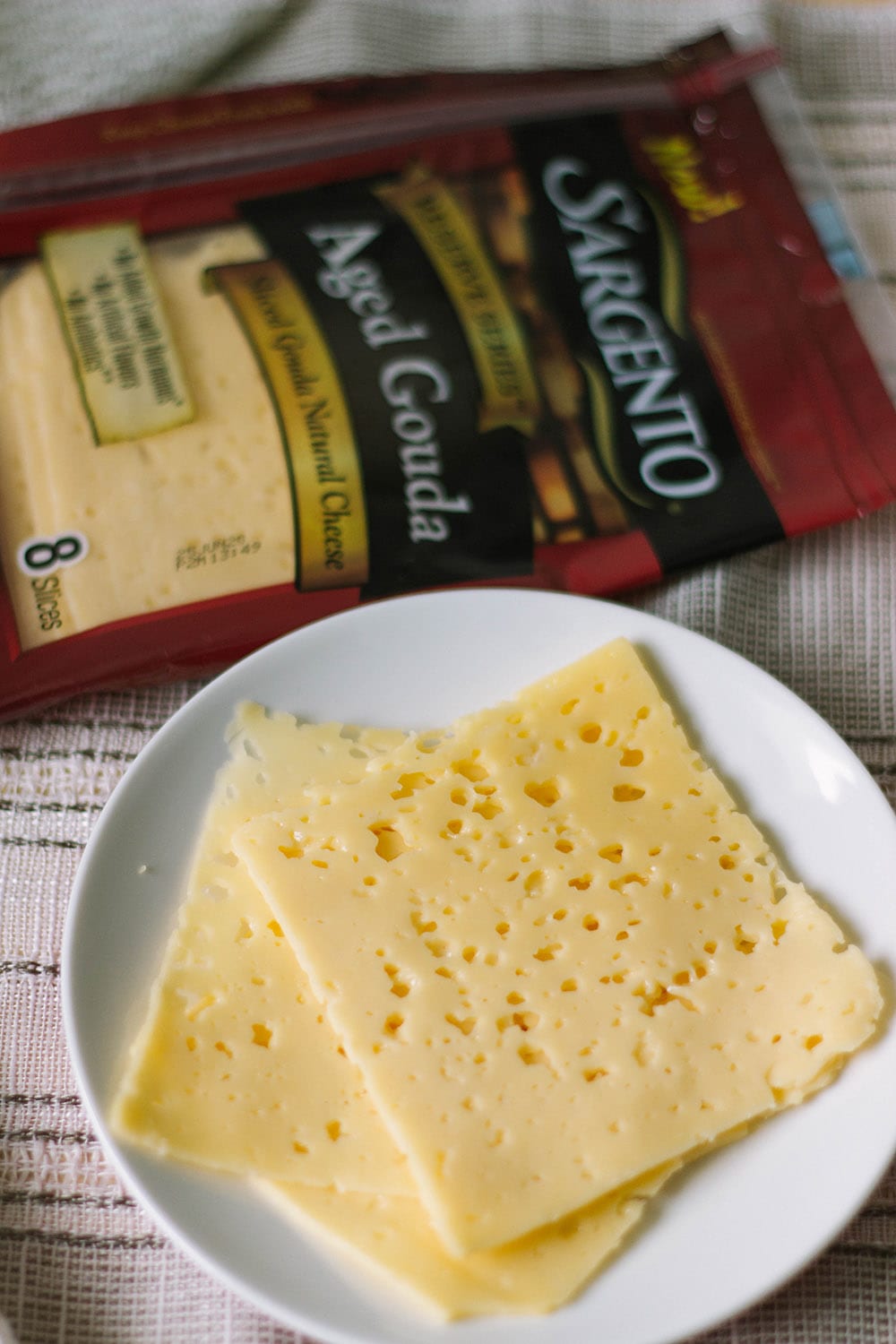 Sargento Aged Gouda slices on a plate
