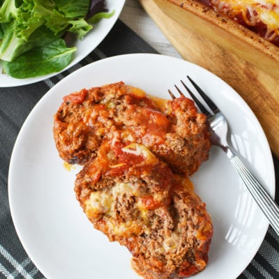 Sliced of cheese sliced meatloaf on a plate with fork