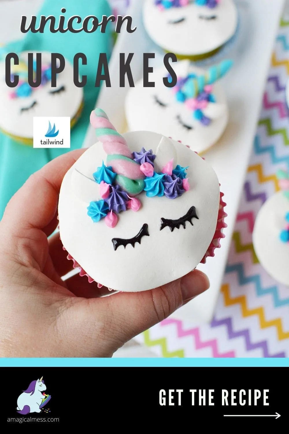 holding a cupcake with a unicorn face
