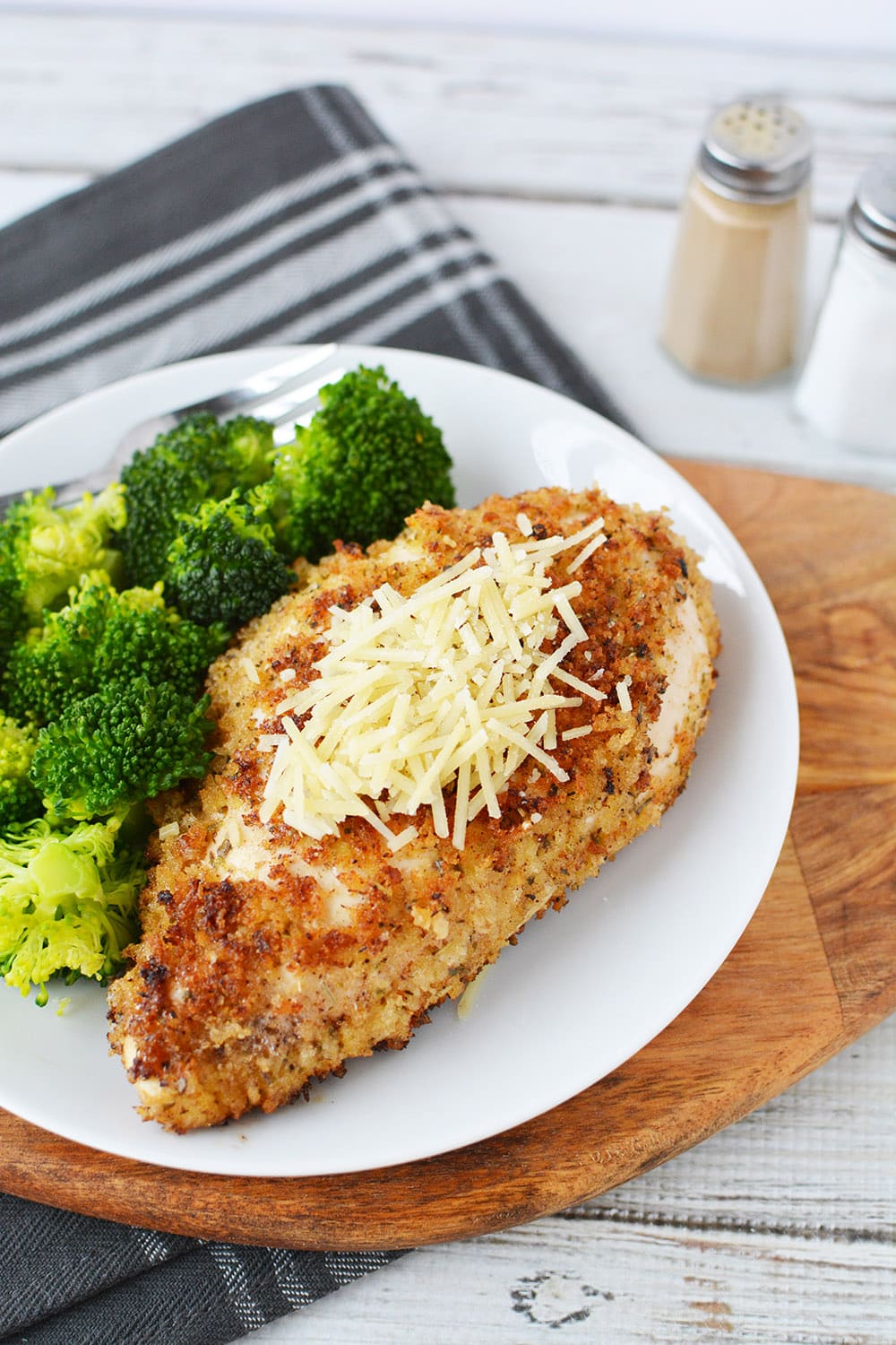 Herb crusted chicken and broccoli dinner on a plate.