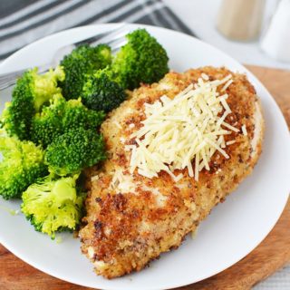 Parmesan crusted chicken on a plate with broccoli