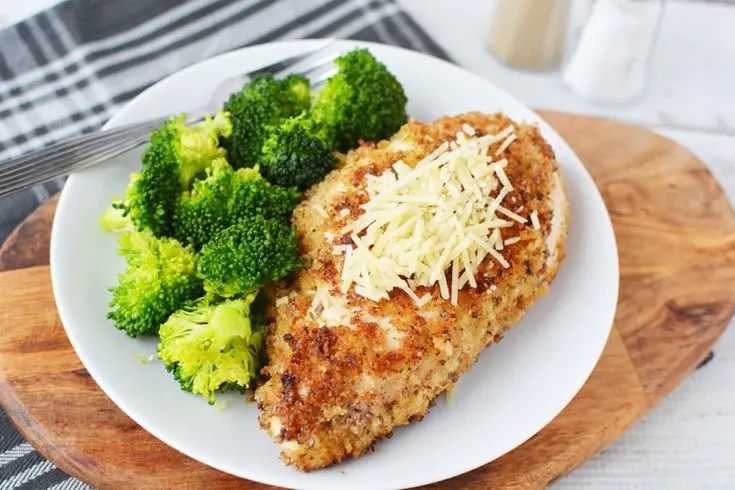 Parmesan crusted chicken on a plate with broccoli