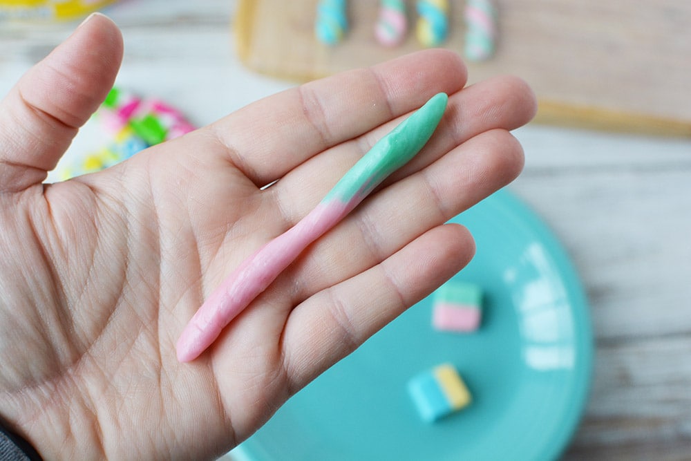 Holding a rolled starburst to make a unicorn horn.