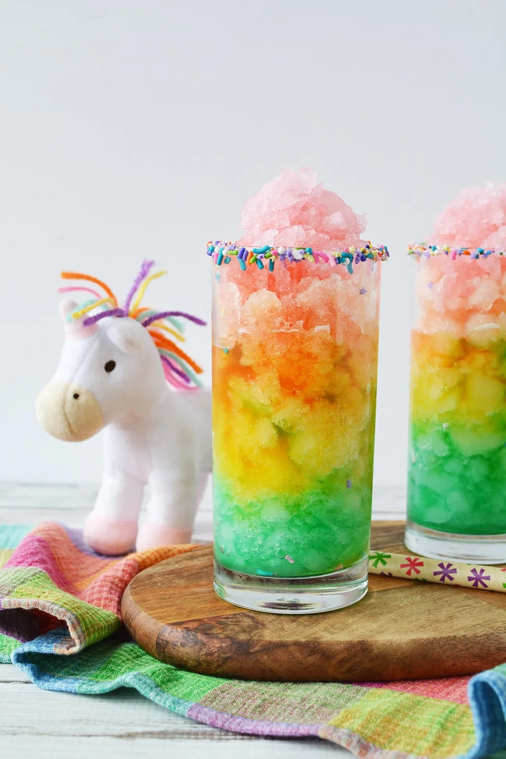 Unicorn slush in rainbow layers in glass.