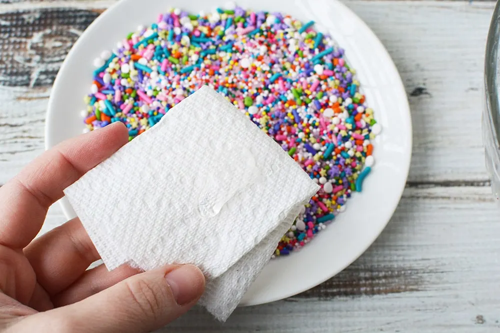 Paper towel and plate of sprinkles.