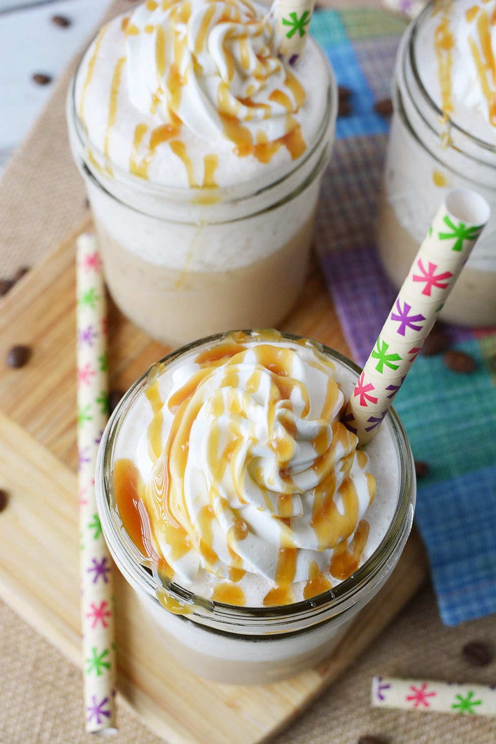 Caramel frappuccino drinks in glasses with whipped cream and caramel sauce.