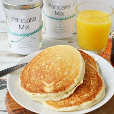 pancakes on a plate and jars and orange juice