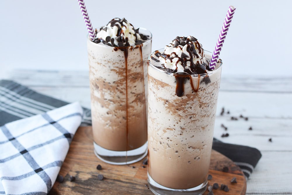 Two mocha frappuccinos in glasses.