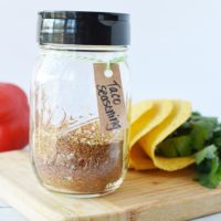 jar of homemade taco seasoning mix on a board