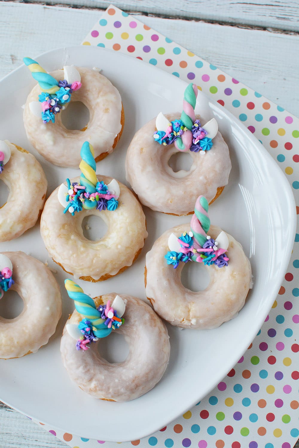 Unicorn donuts on a plate.