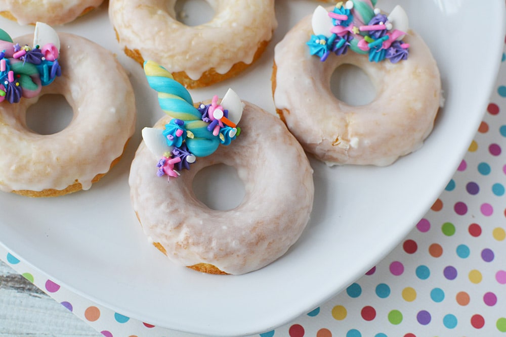 Unicorn donuts on a plate.