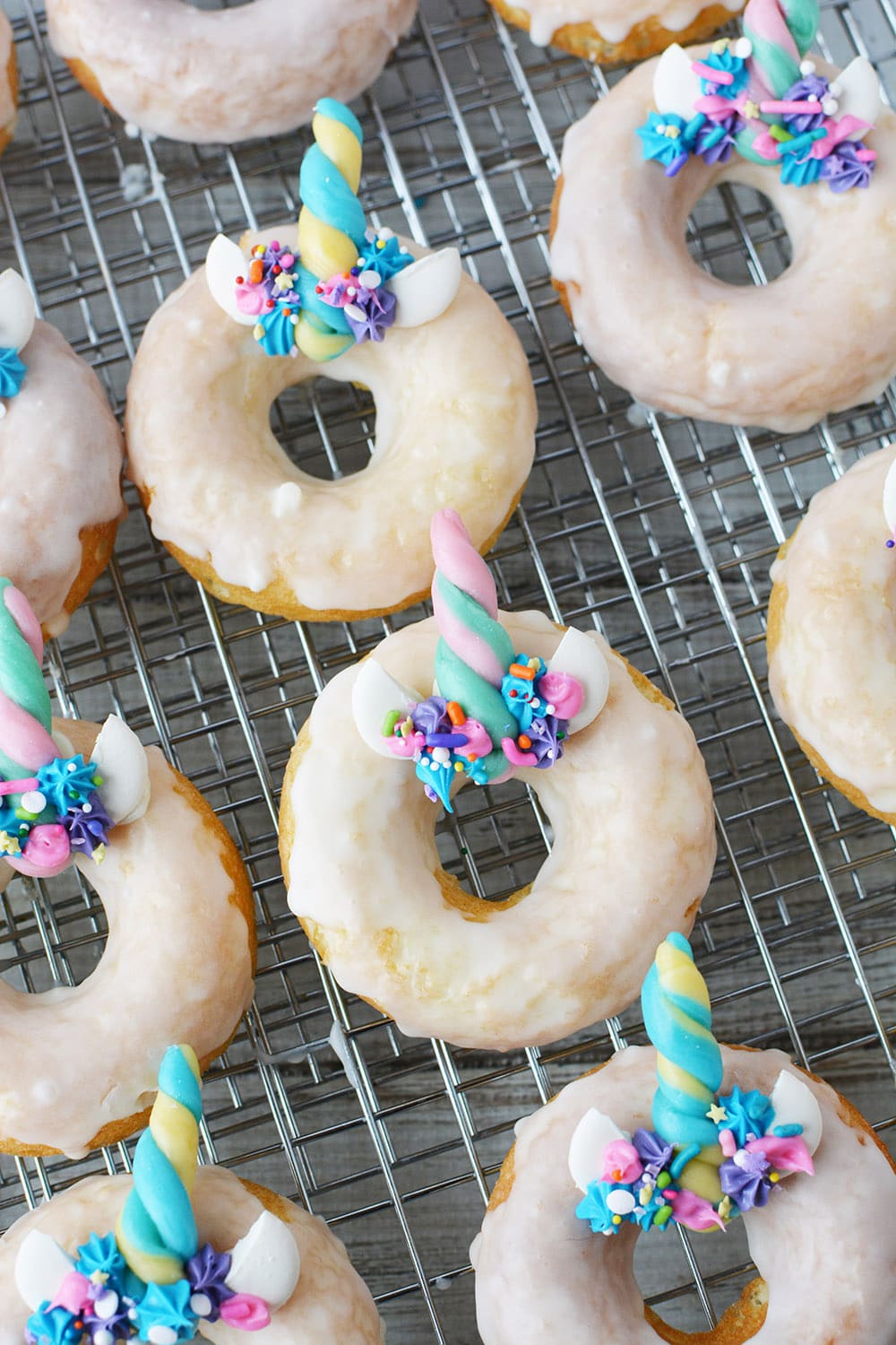 rows of unicorn donuts on a rack