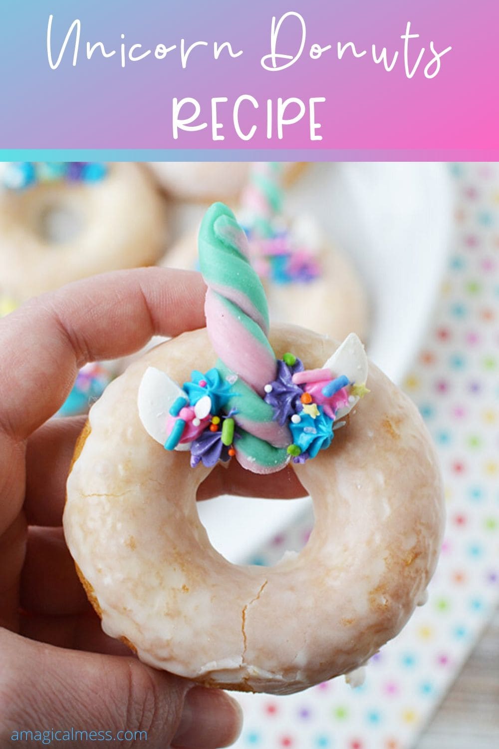 holding a unicorn donut with a candy horn
