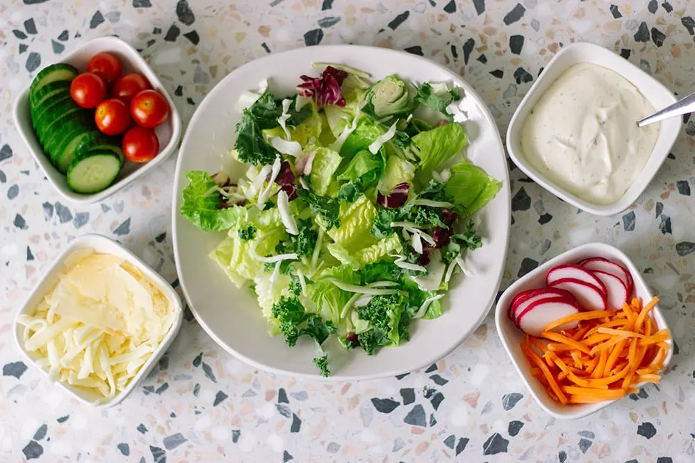 Salad with toppings in bowls.