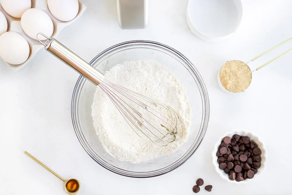 Flour mixture for cookies in a mixing bowl with a whisk.