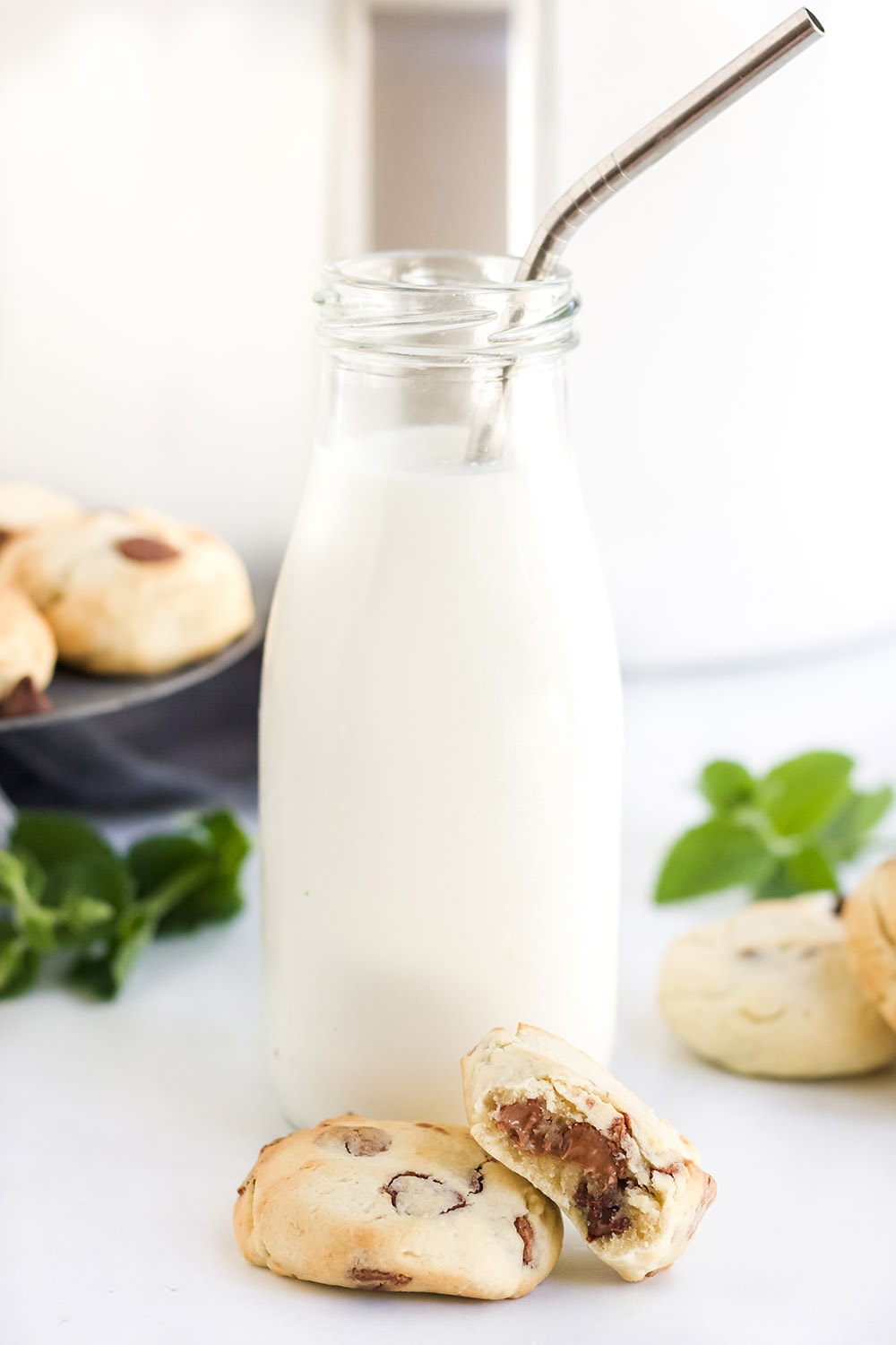 cookies in front of a jar of milk