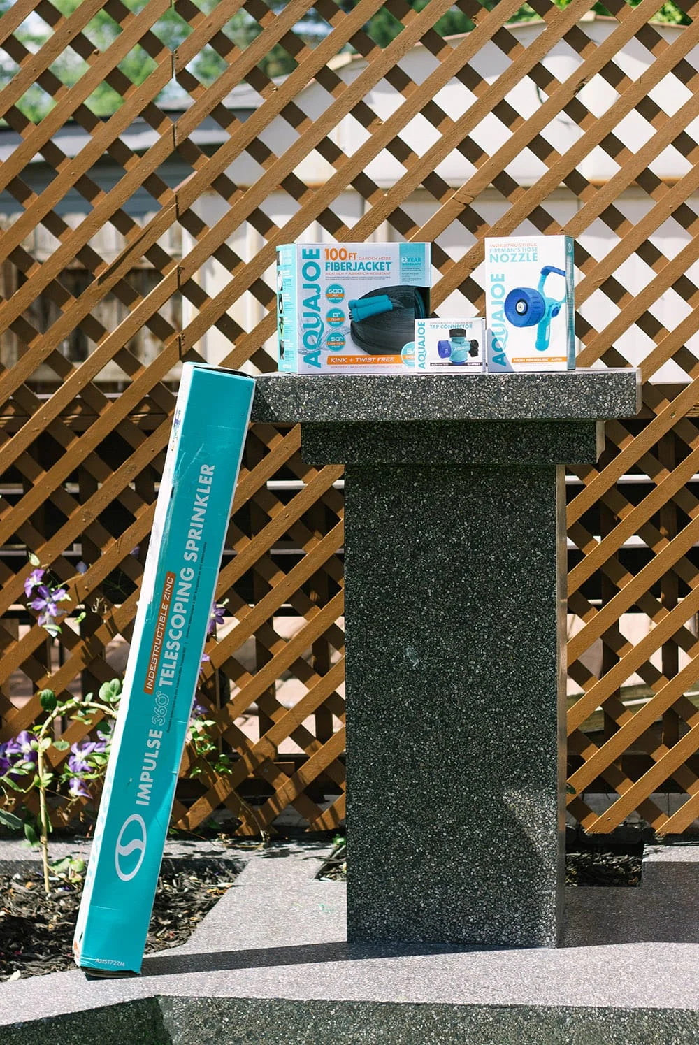 Aqua joe products on a terrazzo yard sculpture.