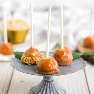 Mini caramel apples on a stand on a table