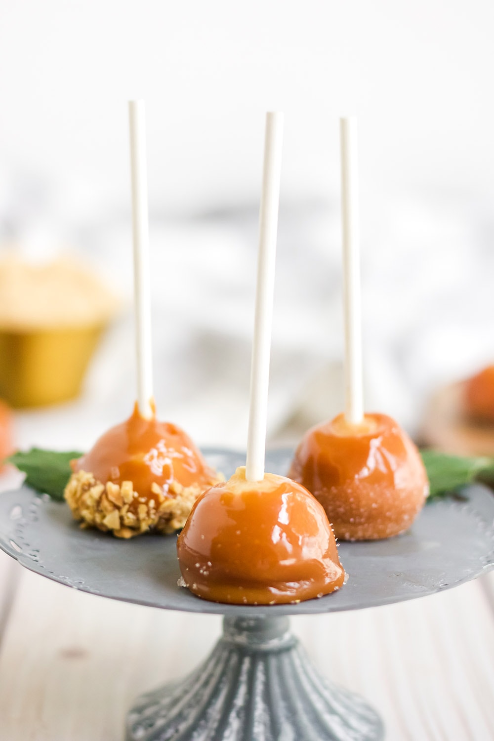 Mini caramel apples on a stand.