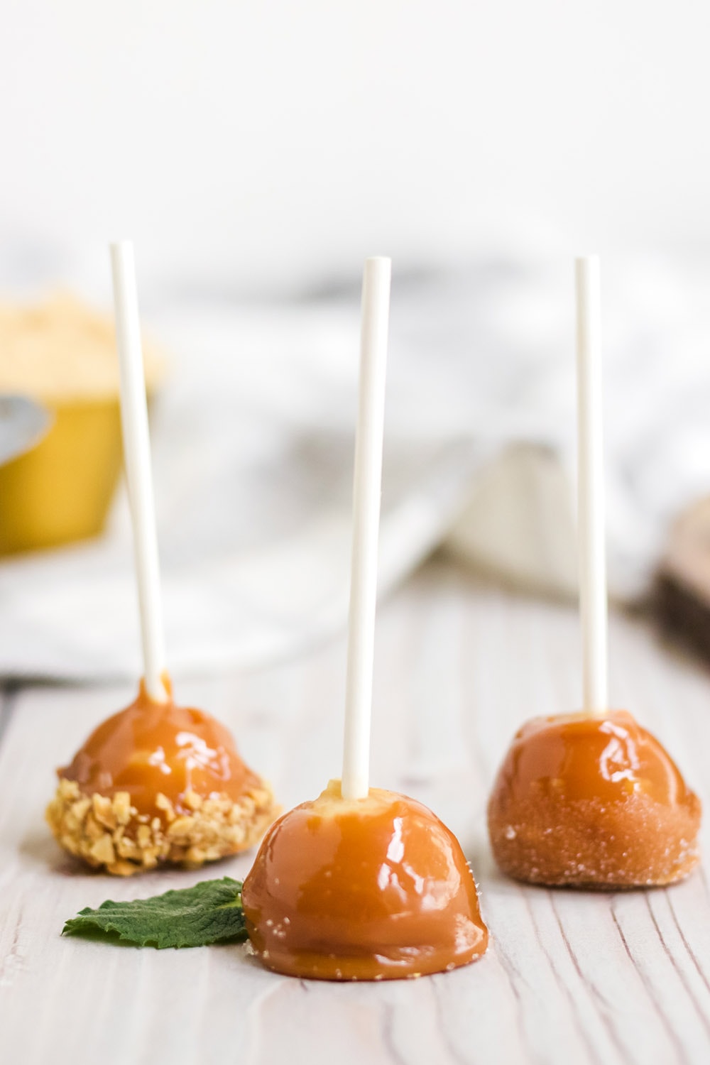 Mini candied apples on a table.